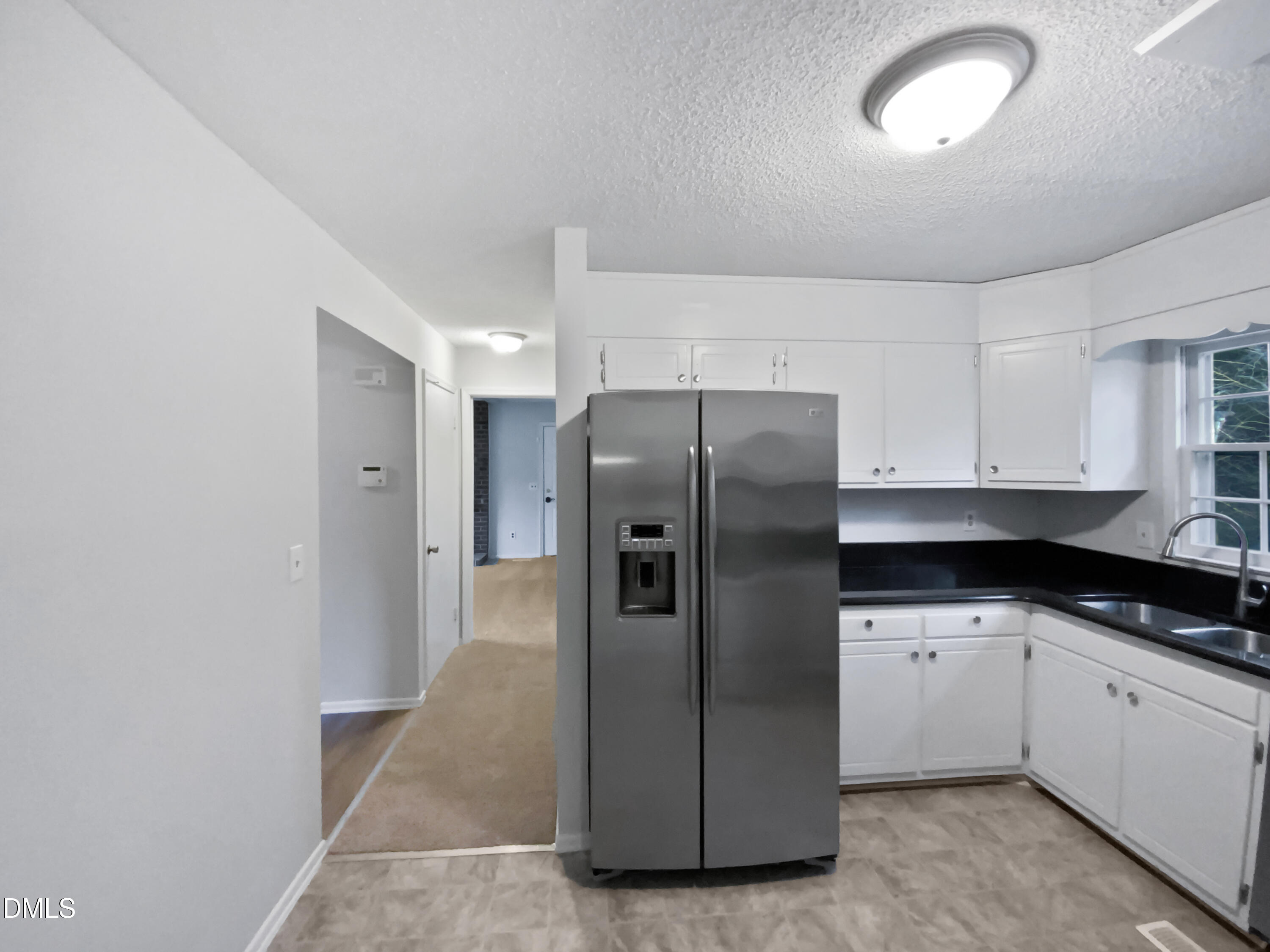 3136 Merrianne Drive Raleigh, NC 27607 - Photo 10 of 20 a kitchen with stainless steel appliances a refrigerator sink and cabinets