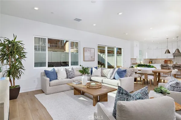 a living room with furniture a large window and a table