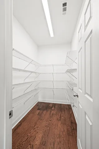 a view of walk in closet with empty racks