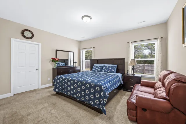 a bedroom with a bed couch and window