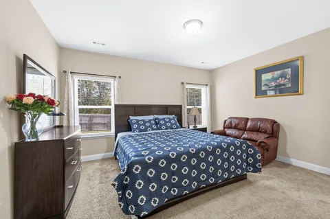 a bedroom with a bed and a potted plant
