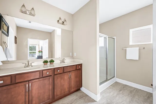 a bathroom with a double vanity sink and mirror