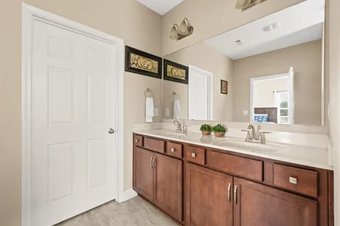 a bathroom with a double vanity sink and a mirror