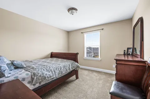 a bedroom with a bed and a couch