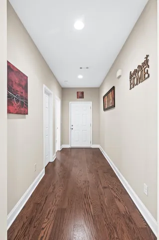 a view of empty room with wooden floor