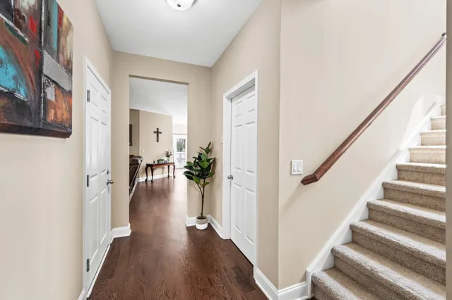a view of entryway and hall with wooden floor