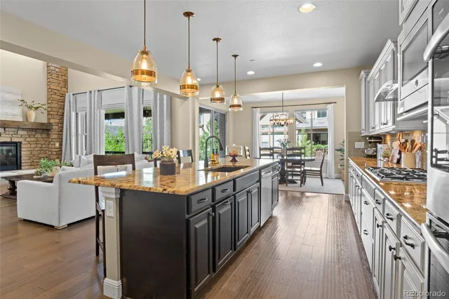 a kitchen with counter top space and wooden floor