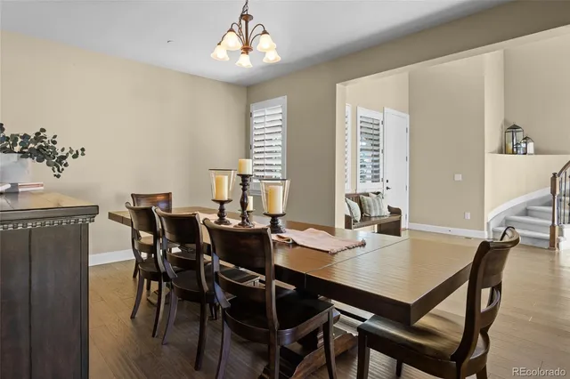 a view of a dining room with furniture and chandelier