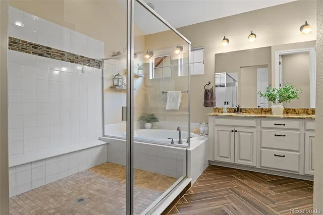 a spacious bathroom with a shower sink and mirror