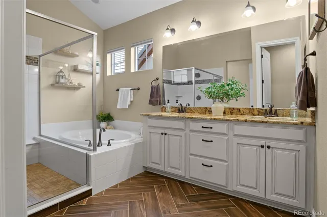 a bathroom with a tub sink and mirror