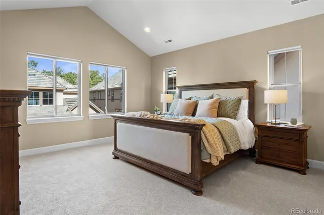 a spacious bedroom with a bed and a large window