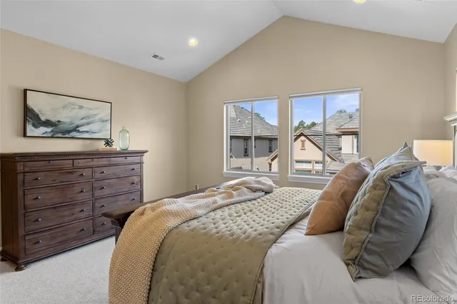 a bedroom with a bed and a painting on the wall
