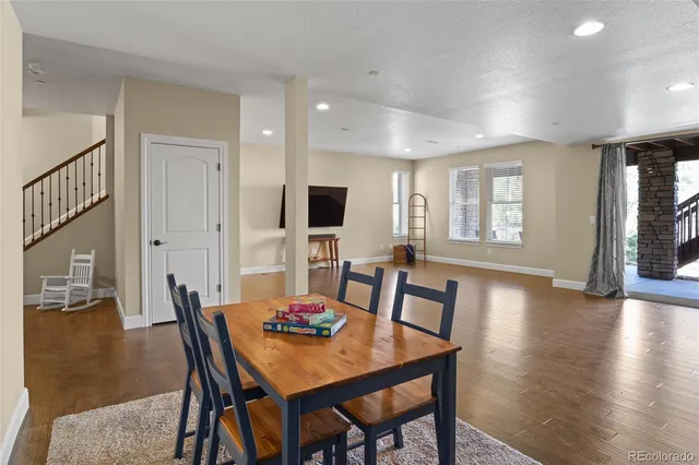 a view of a dining room with furniture window and wooden floor