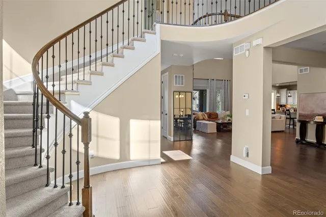 a view of entryway and hall with wooden floor