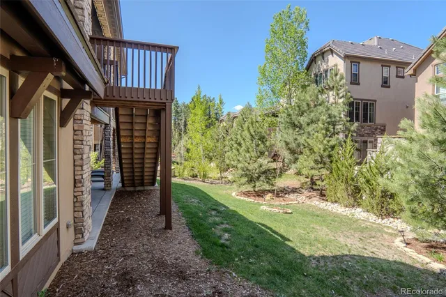 a view of a pathway with plants and wooden fence
