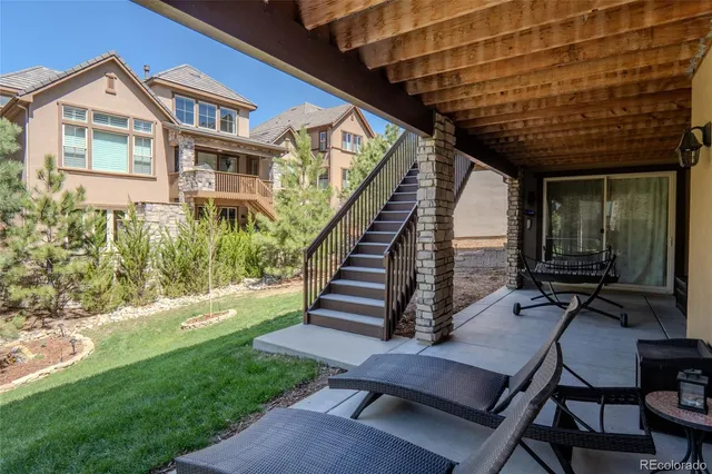 a view of a chairs and table in patio with wooden fence