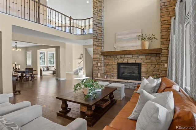 a living room with furniture a fireplace and a table