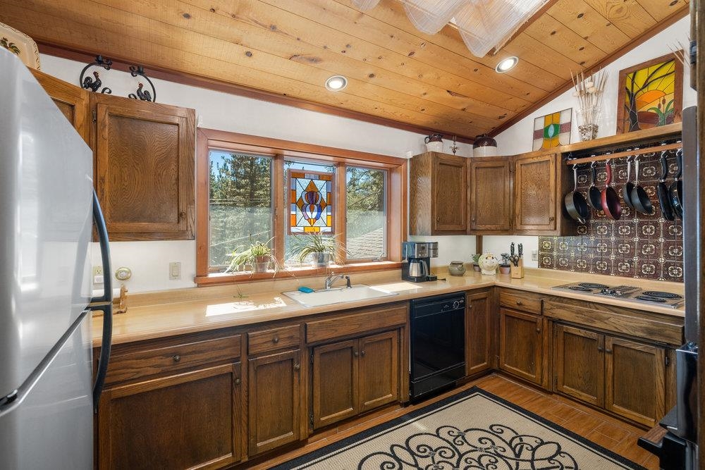 138 Tiger Tail Road Olympic Valley, CA 96146 - Photo 13 of 28 a kitchen with a sink stove and cabinets