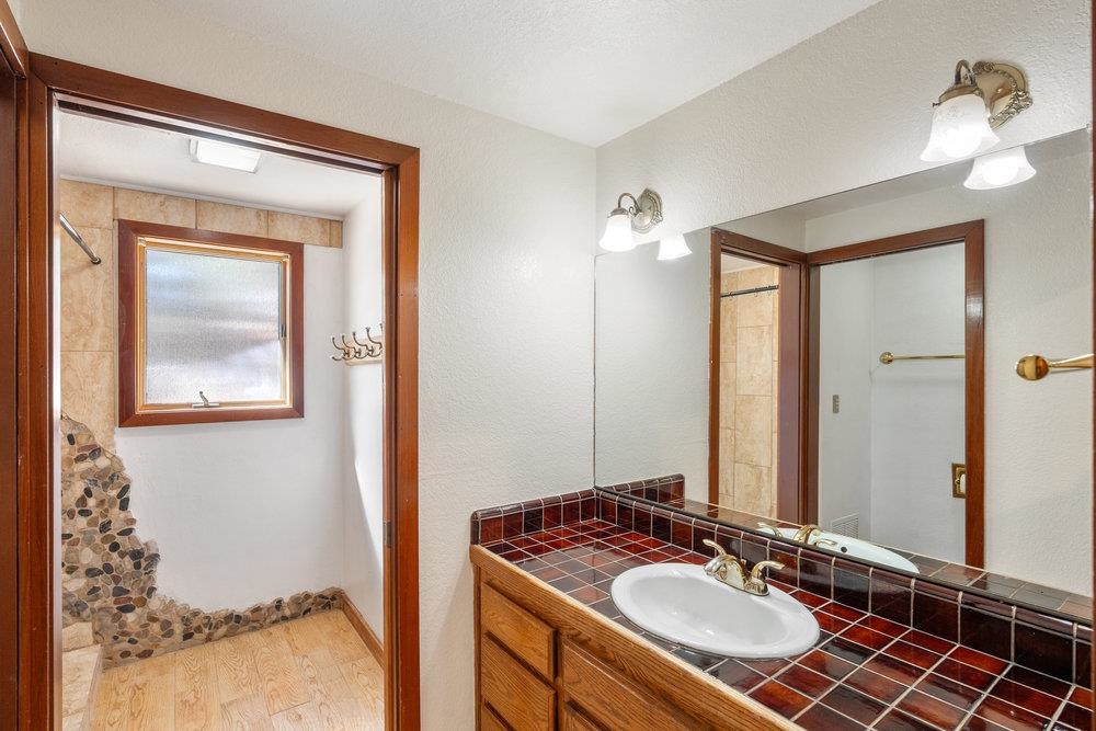 138 Tiger Tail Road Olympic Valley, CA 96146 - Photo 24 of 28 a bathroom with a sink vanity granite and a mirror