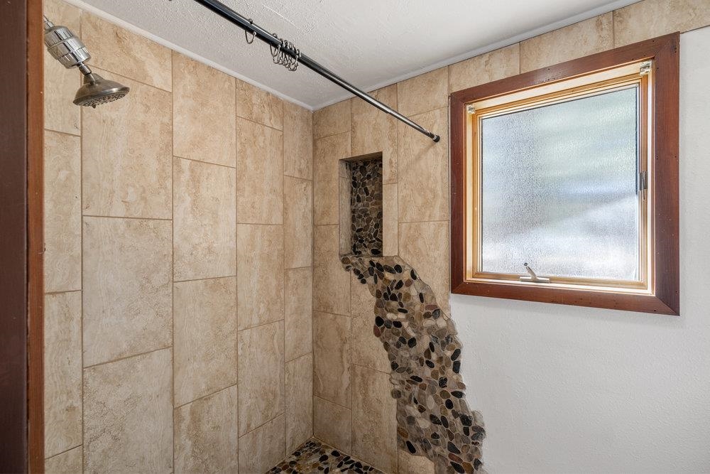 138 Tiger Tail Road Olympic Valley, CA 96146 - Photo 25 of 28 a bathroom with a shower curtain and a window