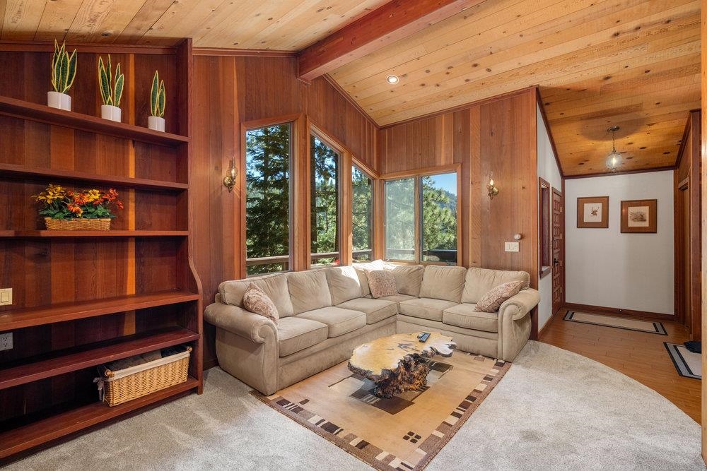 138 Tiger Tail Road Olympic Valley, CA 96146 - Photo 4 of 28 a living room with furniture a rug and a book shelf
