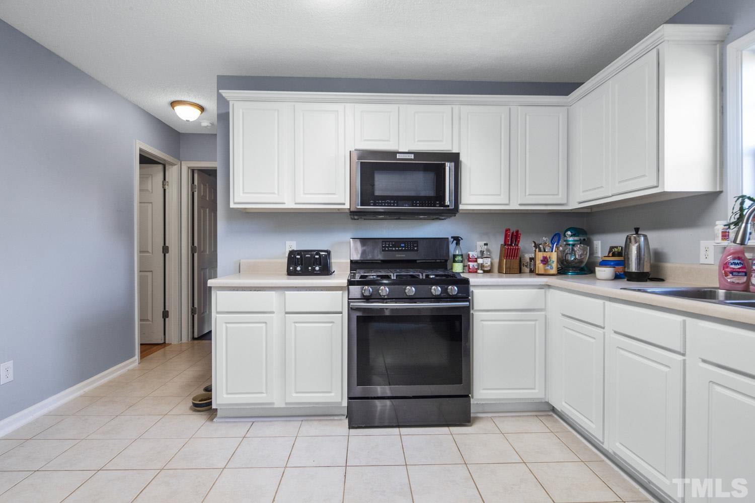 476 Saddle Ridge Drive Willow Spring, NC 27592 - Photo 11 of 30 a kitchen with cabinets stainless steel appliances and a sink