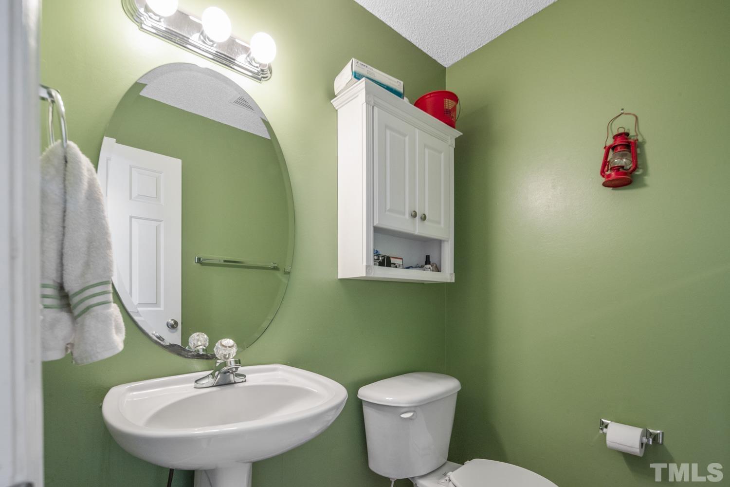 476 Saddle Ridge Drive Willow Spring, NC 27592 - Photo 14 of 30 a bathroom with a toilet sink and mirror