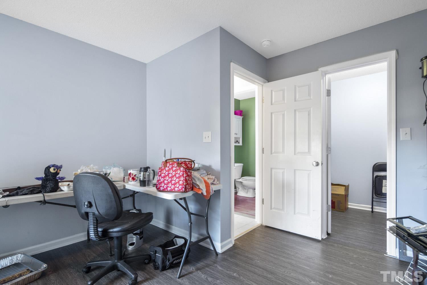 476 Saddle Ridge Drive Willow Spring, NC 27592 - Photo 16 of 30 a view of a workspace with furniture and a gate