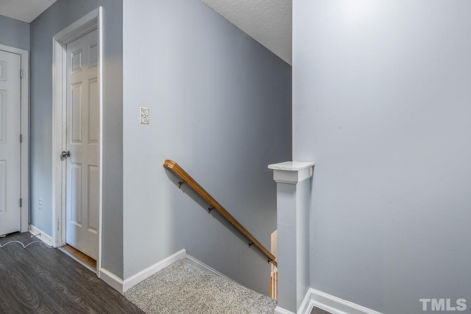 476 Saddle Ridge Drive Willow Spring, NC 27592 - Photo 18 of 30 a view of a hallway with wooden floor and staircase