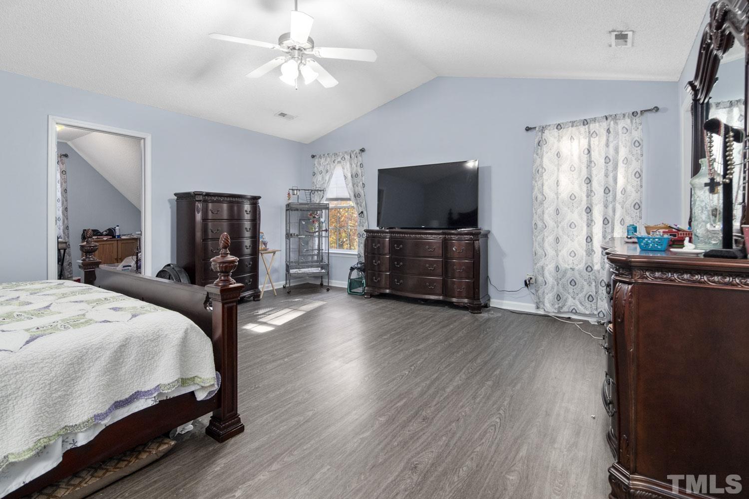 476 Saddle Ridge Drive Willow Spring, NC 27592 - Photo 19 of 30 a bedroom with a bed and wooden floor