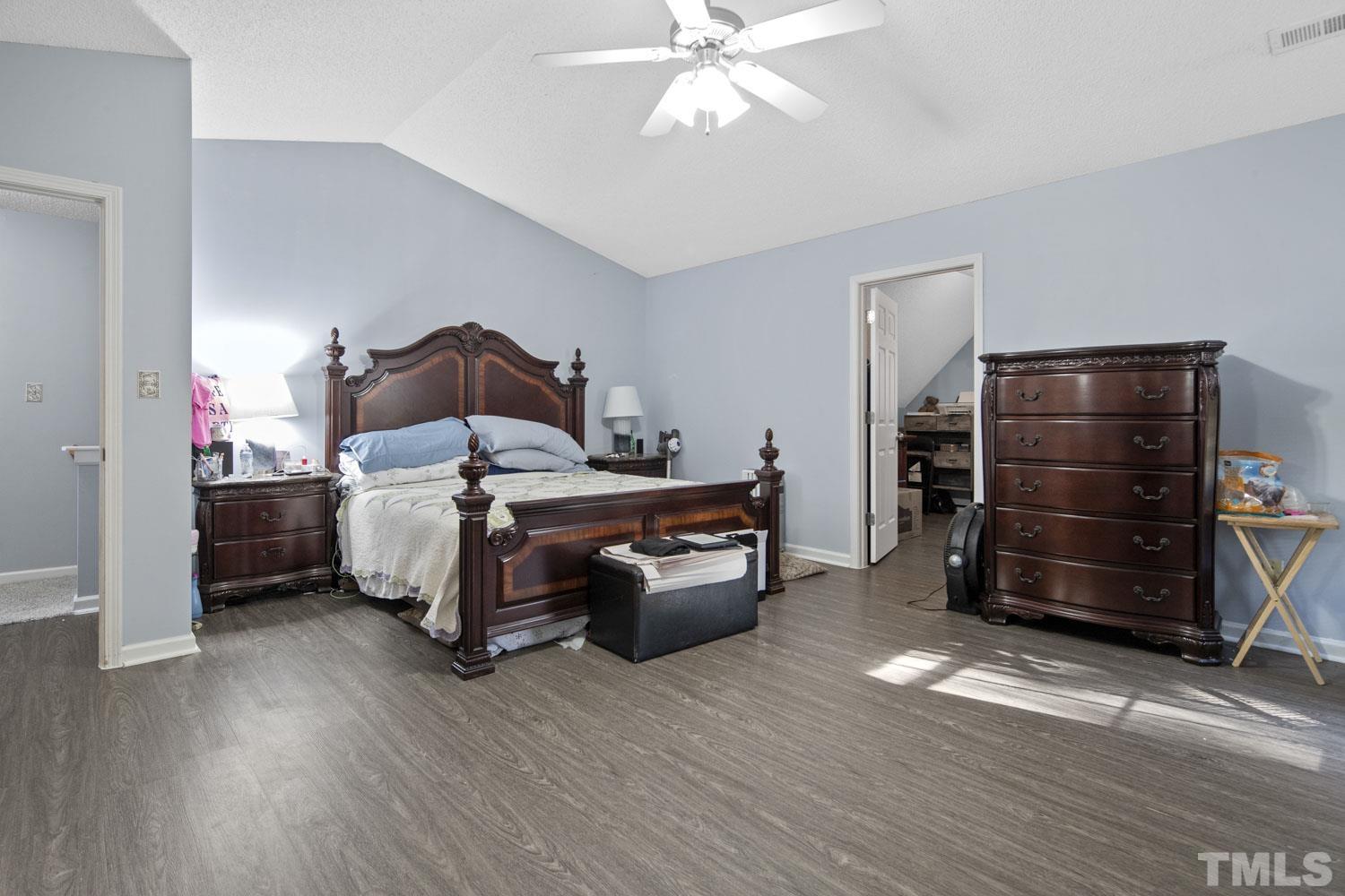 476 Saddle Ridge Drive Willow Spring, NC 27592 - Photo 20 of 30 a bedroom with a bed and a chandelier