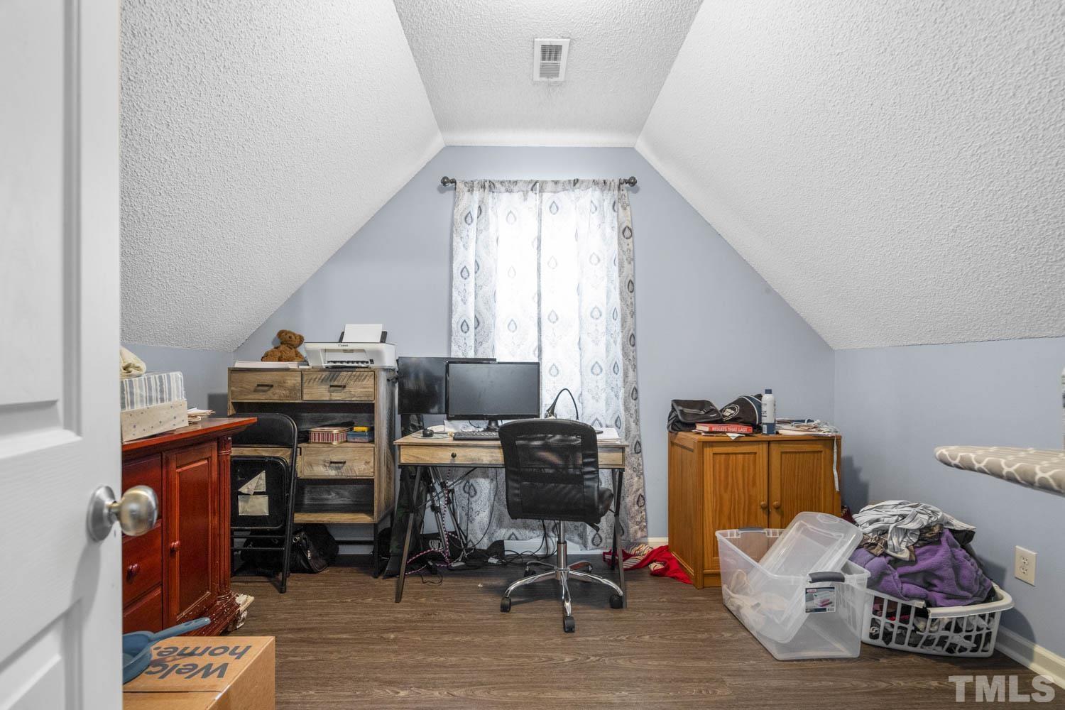 476 Saddle Ridge Drive Willow Spring, NC 27592 - Photo 21 of 30 a view of a workspace with furniture and a window