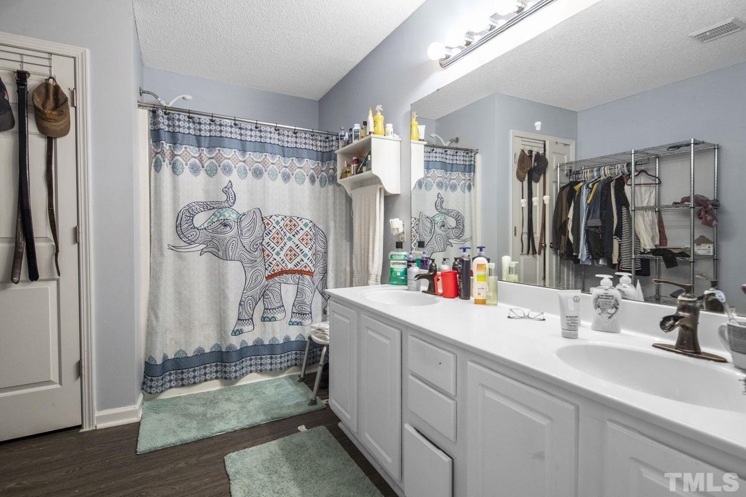 476 Saddle Ridge Drive Willow Spring, NC 27592 - Photo 22 of 30 a bathroom with a double vanity sink mirror and shower