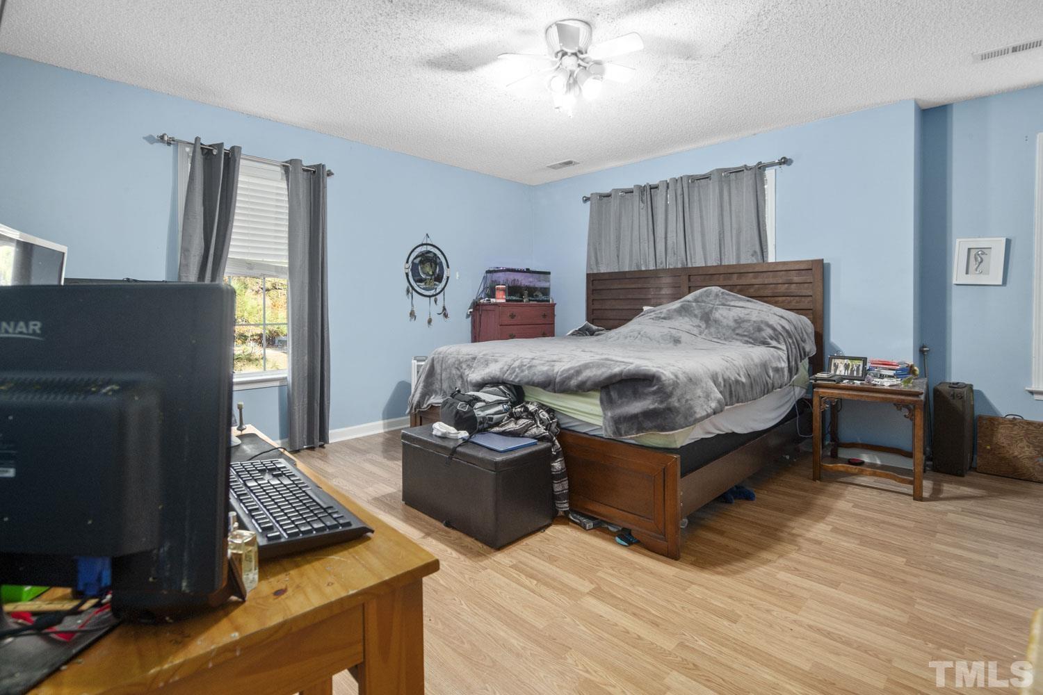 476 Saddle Ridge Drive Willow Spring, NC 27592 - Photo 23 of 30 a bed room with a bed and a television