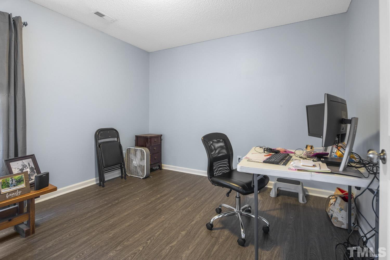 476 Saddle Ridge Drive Willow Spring, NC 27592 - Photo 25 of 30 a view of a workspace with furniture and wooden floor