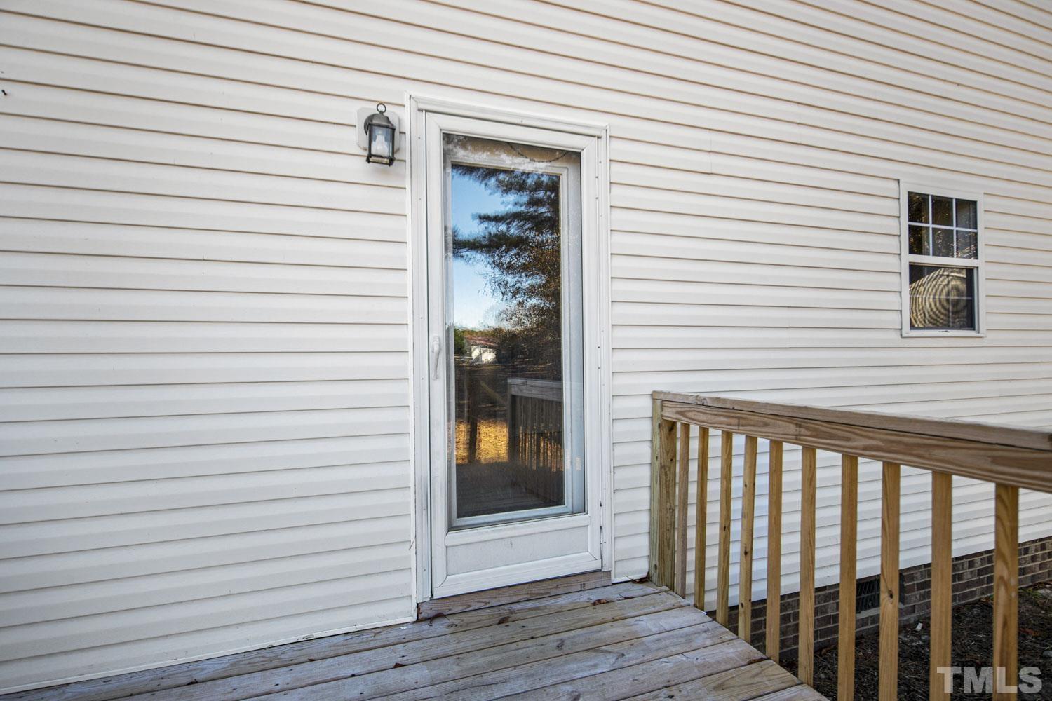 476 Saddle Ridge Drive Willow Spring, NC 27592 - Photo 27 of 30 a view of a porch with a door and wooden floor
