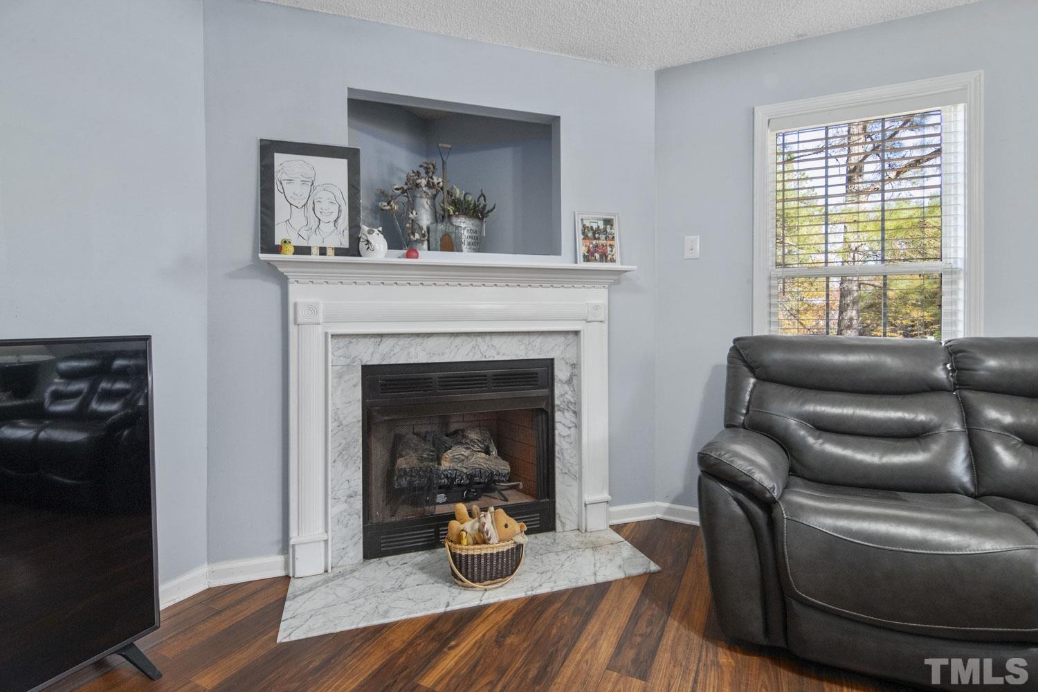 476 Saddle Ridge Drive Willow Spring, NC 27592 - Photo 7 of 30 a living room with furniture and a fireplace