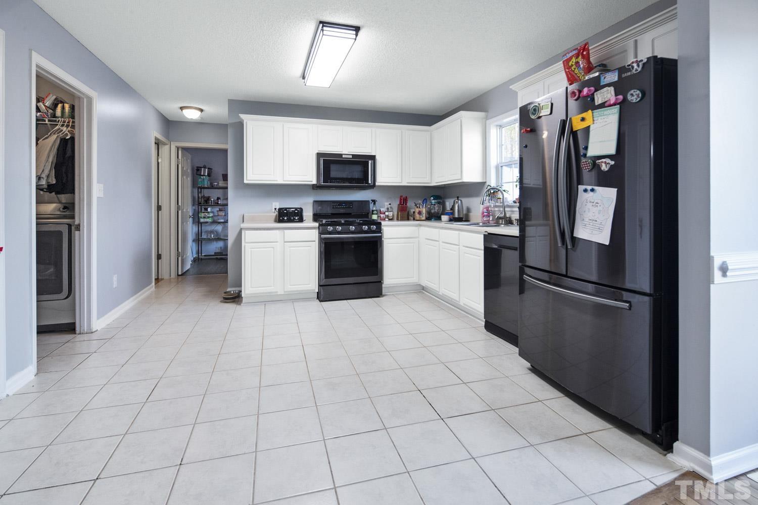 476 Saddle Ridge Drive Willow Spring, NC 27592 - Photo 10 of 30 a kitchen with stainless steel appliances granite countertop a refrigerator and a stove top oven