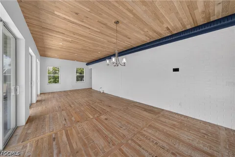 a view of a room with wooden floors and ceiling fan