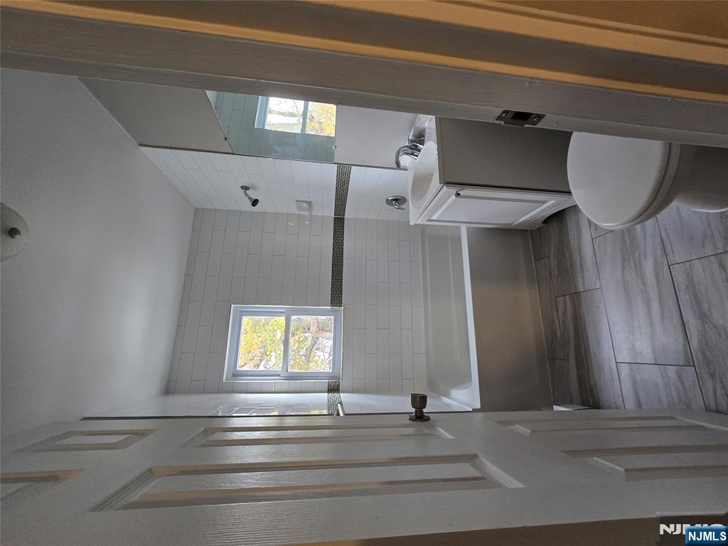 274 Park Street, Unit 7 Hackensack, NJ 07601 - Photo 2 of 3 a bathroom with a sink a toilet a tub and shower