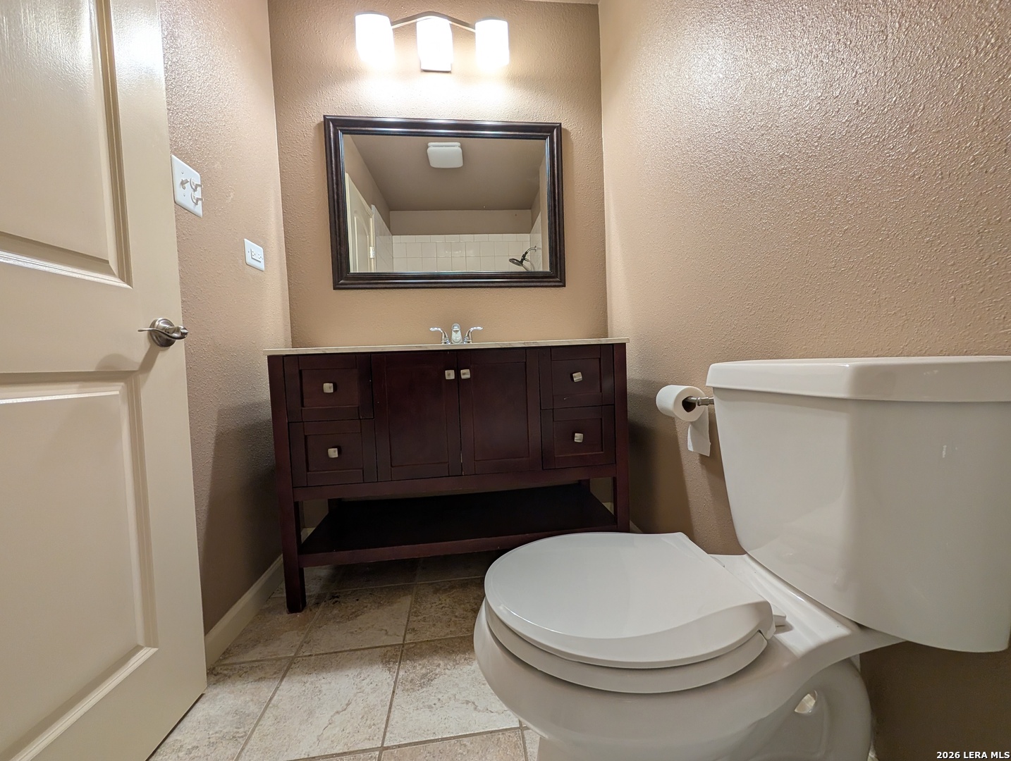 551 Terminal Loop Road, Unit D5 McQueeney, TX 78123 - Photo 21 of 42 a bathroom with a toilet a sink and mirror
