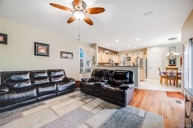a living room with furniture and a wooden floor