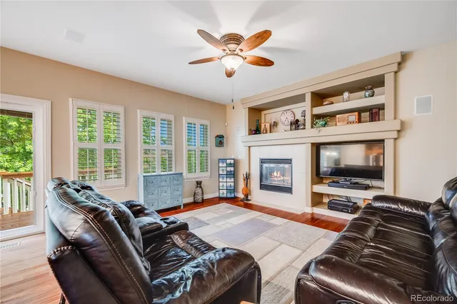 a living room with furniture fireplace and flat screen tv