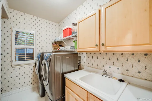 a bathroom with a sink a washer and dryer