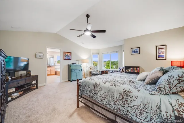 a bedroom with a large bed and flat tv screen on dresser