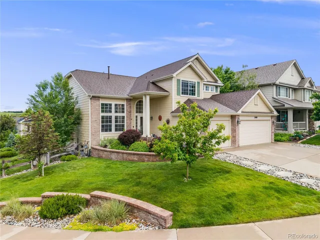 a front view of house with yard and green space