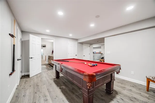 a living room with a table and pool table