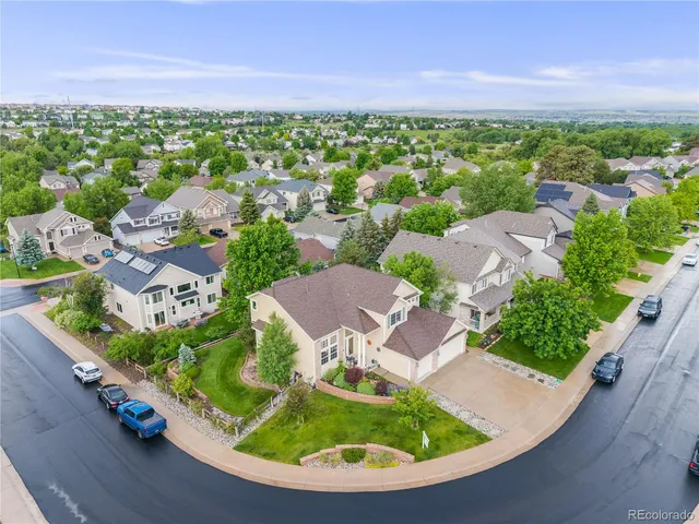 an aerial view of a house with garden space and street view