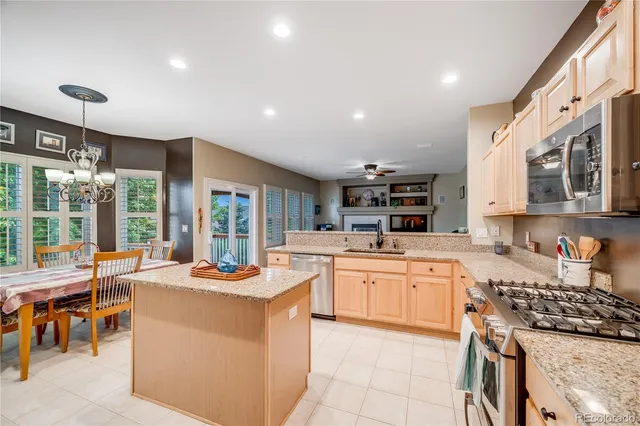 a kitchen with stainless steel appliances granite countertop a stove oven and a refrigerator