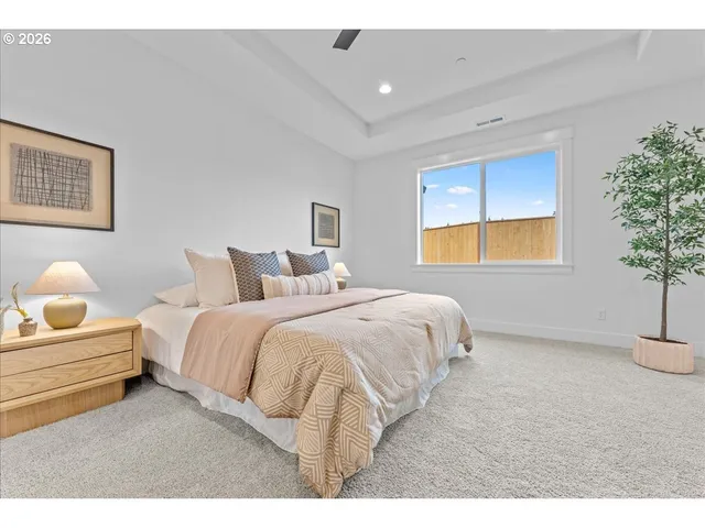 a bedroom with a bed and a potted plant
